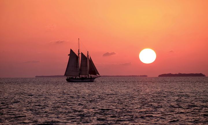 Two-mast schooner under sail at Key West sunset