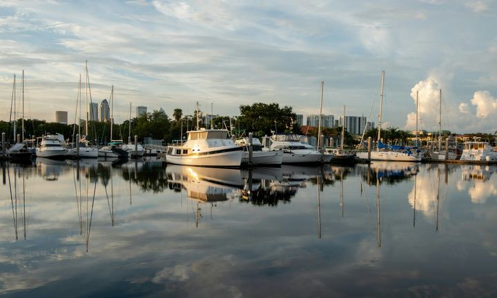 Sailboats and yachts in a Tampa Bay marina with the downtown skyline behind